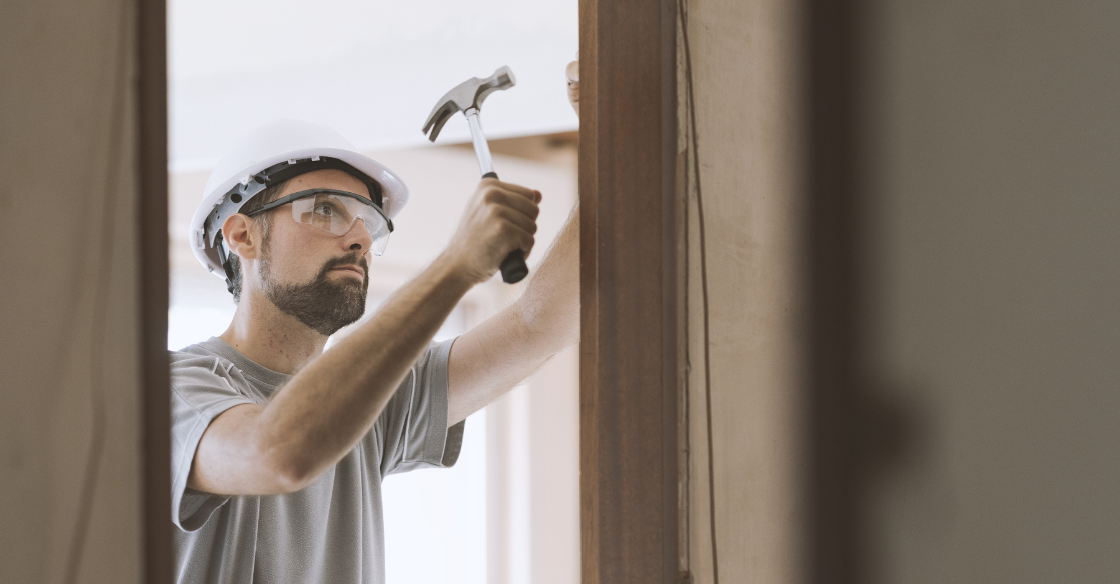 Worker framing out a new door