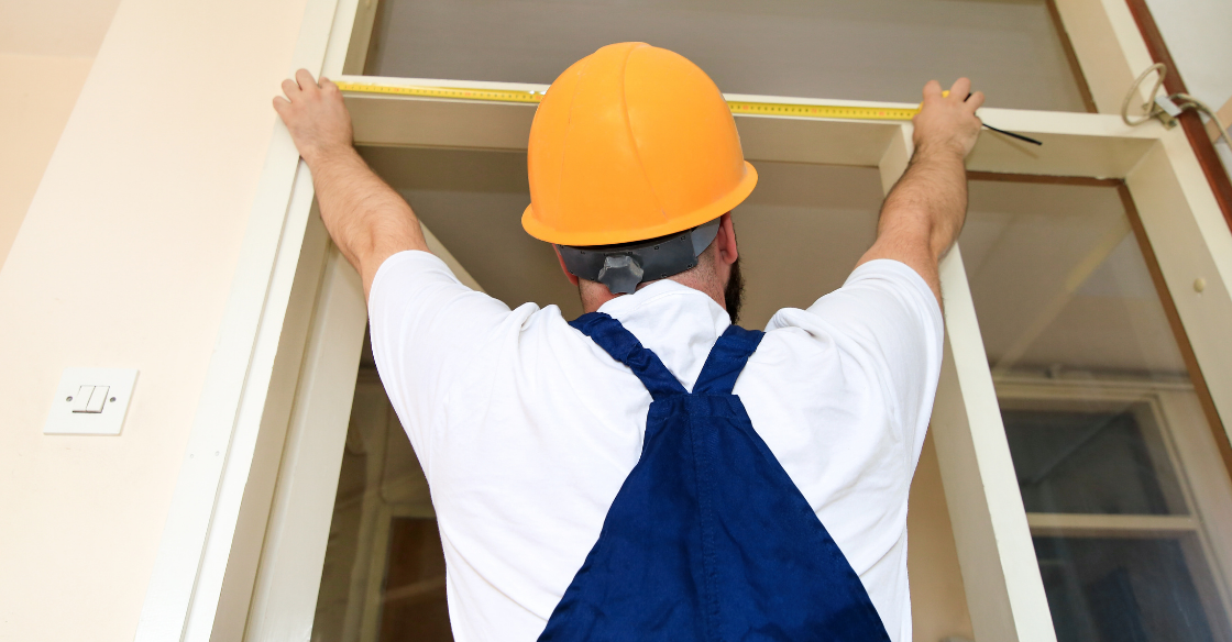 Worker taking measurements for a new door