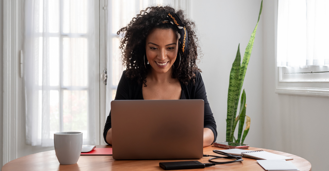 Woman working from home at her dinging table