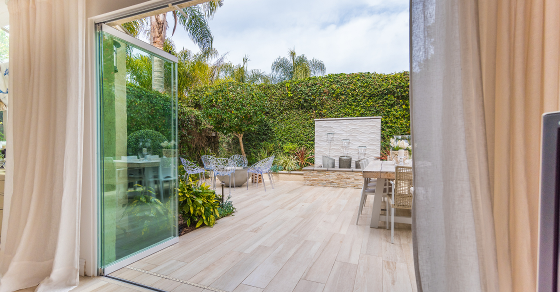 Indoor/outdoor living with frameless glass doors