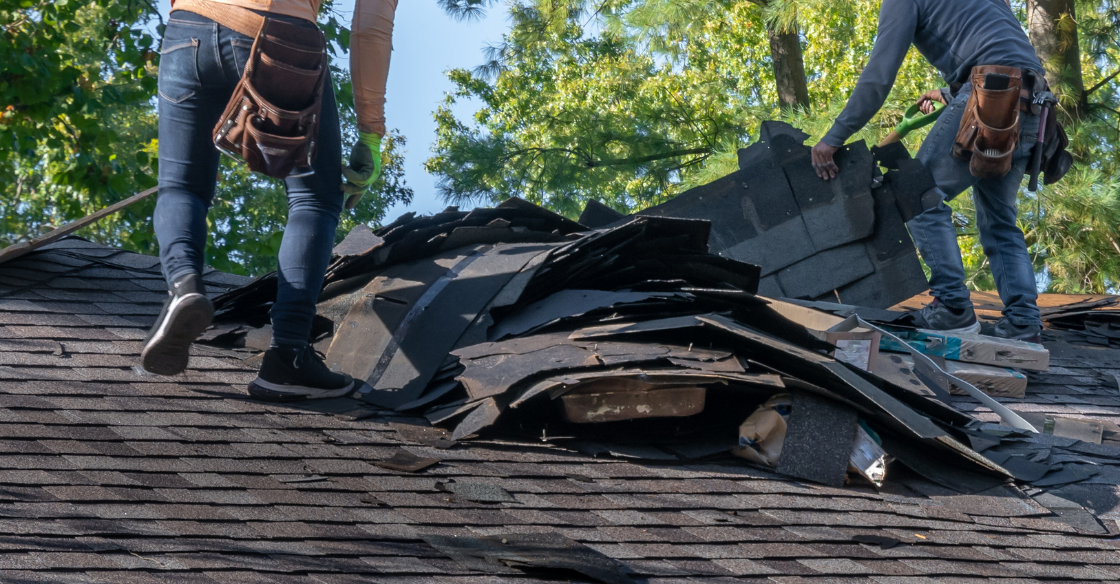 roofers replacing shingles on a roof