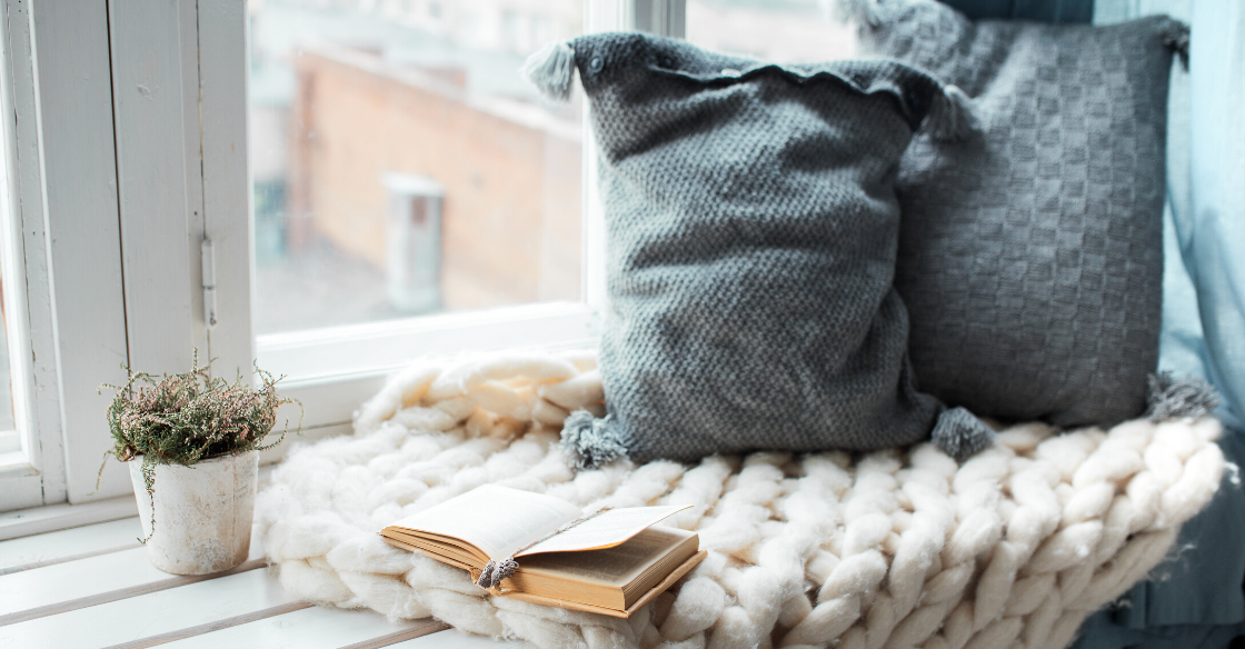 Cozy reading nook with book and pillows