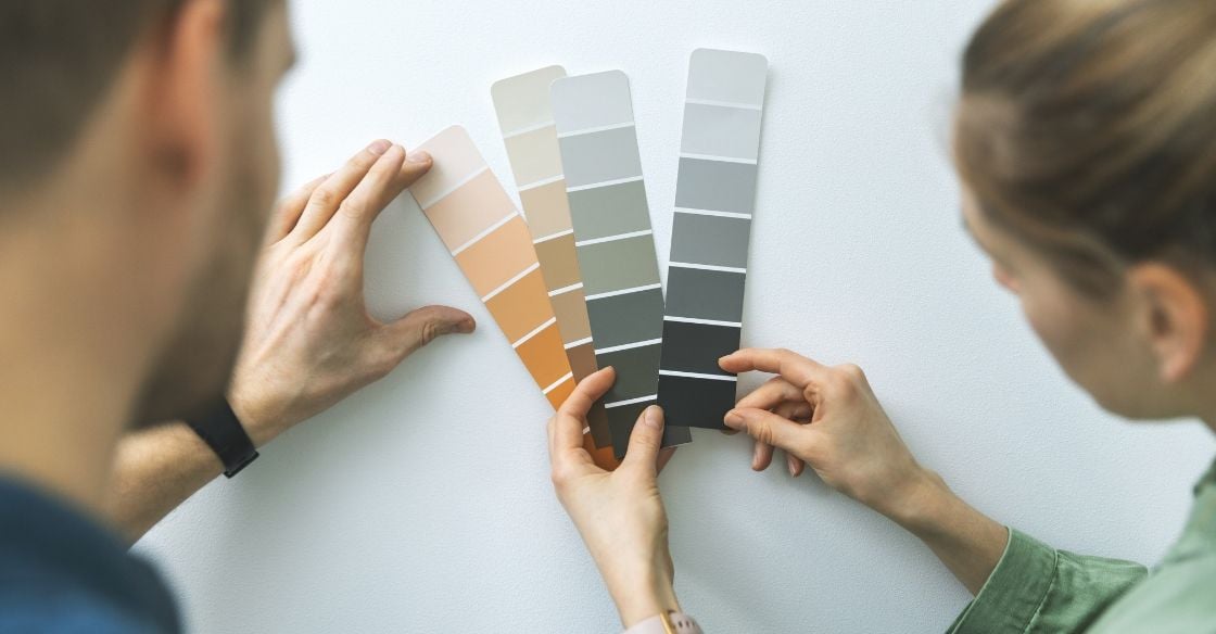 Couple selecting a paint color to update their home