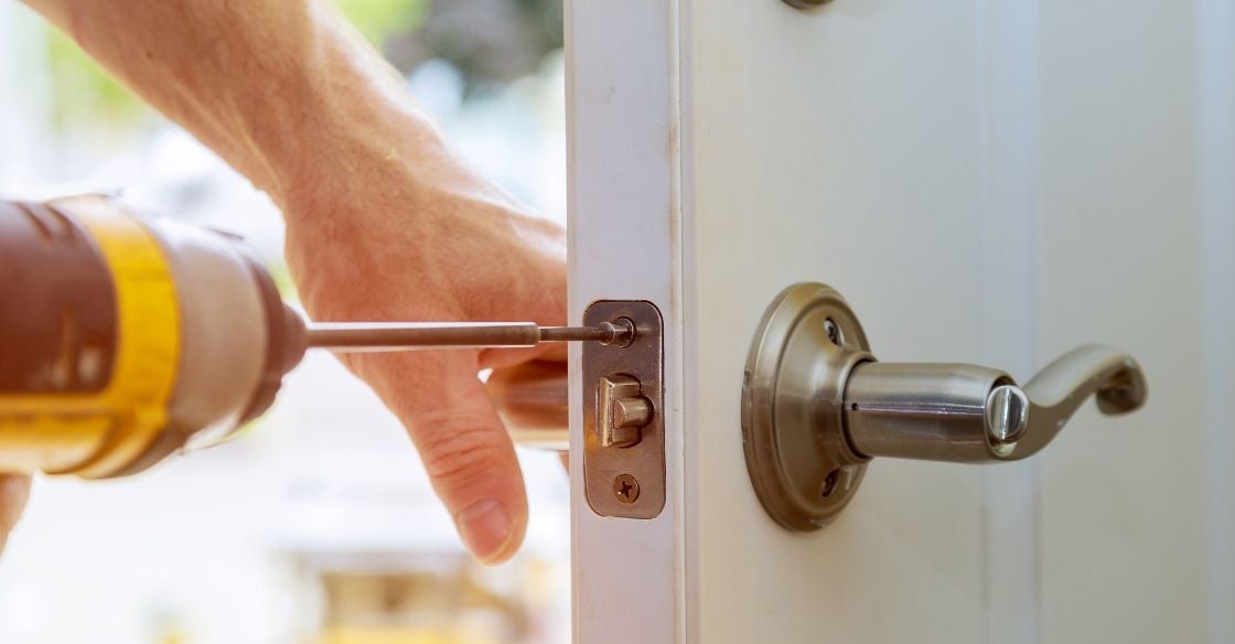 Man replacing an outdated door handle