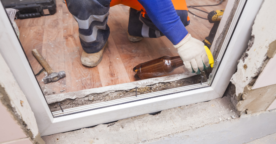 construction worker replacing a door