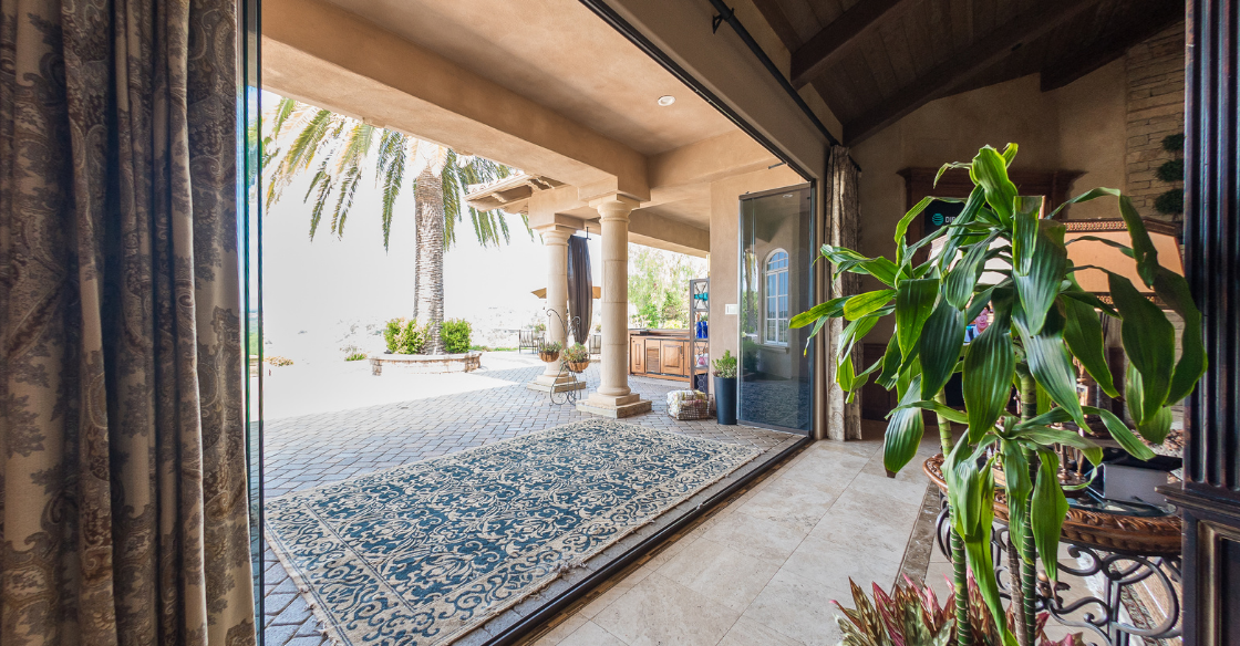 Frameless glass doors leading out to a patio